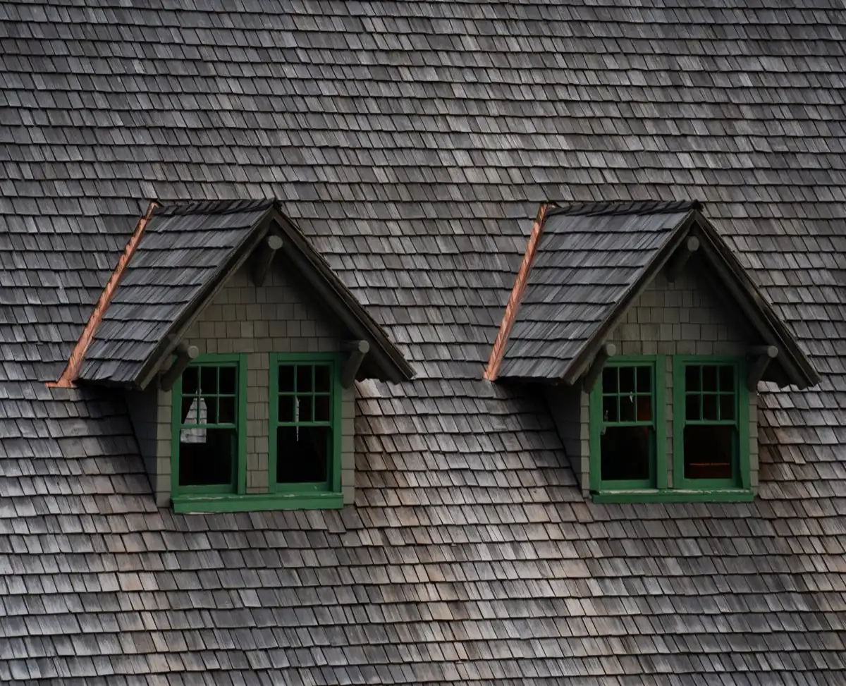 Dormers on a shingle roof in Grand Junction, CO, where step flashing and kickout flashing carry water past the walls